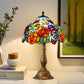 12" Tiffany-style table lamp featuring multicolor floral stained-glass shade on bronze base