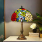 Tiffany-style stained glass table lamp featuring a multicolor dome shade atop a bronze base