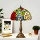 Tiffany-style stained glass table lamp with multicolor dome shade and detailed bronze pedestal base