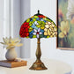 Tiffany-style stained glass table lamp with multicolor dome shade and ornate bronze base