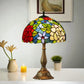 Tiffany-style stained glass table lamp showing a multicolor dome shade and bronze base