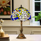 Tiffany-style table lamp with blue-green stained-glass shade and bronze metal base