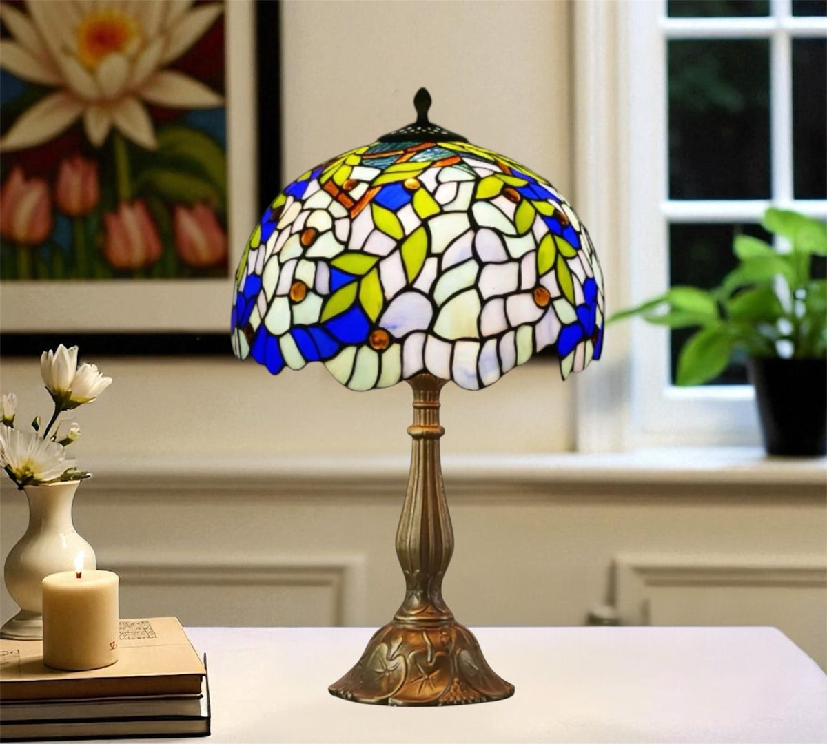 Tiffany-style table lamp with blue-green stained-glass shade and bronze metal base