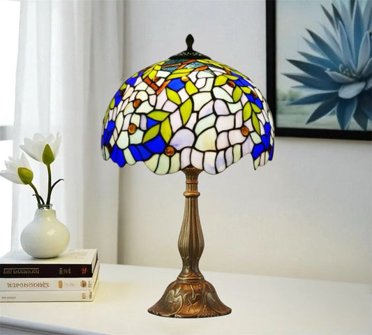 Tiffany-style table lamp with stained-glass shade in white, blue, and green and bronze base