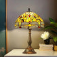 Tiffany-style stained glass table lamp featuring a multicolor shade and bronze metal base