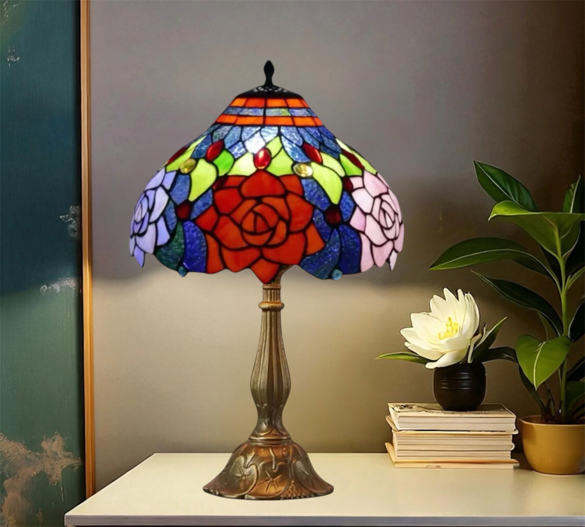 Tiffany-style stained glass table lamp with red rose shade and tall bronze metal stand.