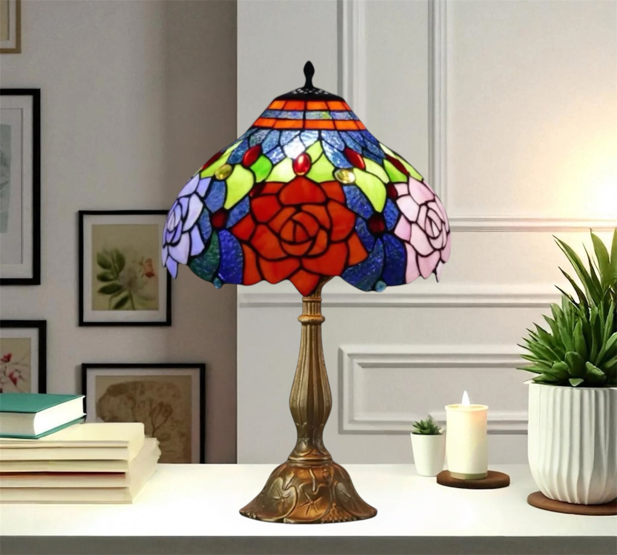Multicolor stained glass table lamp with red floral center, bronze base, black top knob.