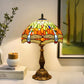 Tiffany table lamp with multicolor stained-glass dome shade and bronze base.