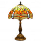 Studio view of Tiffany table lamp: multicolor stained-glass dome shade, bronze metal base.