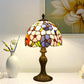 Tiffany table lamp with multicolor stained-glass shade and bronze metal base