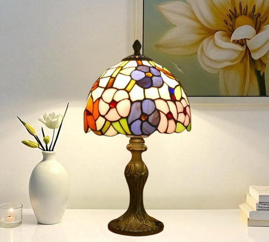 Tiffany table lamp with multicolor stained-glass shade and bronze metal base