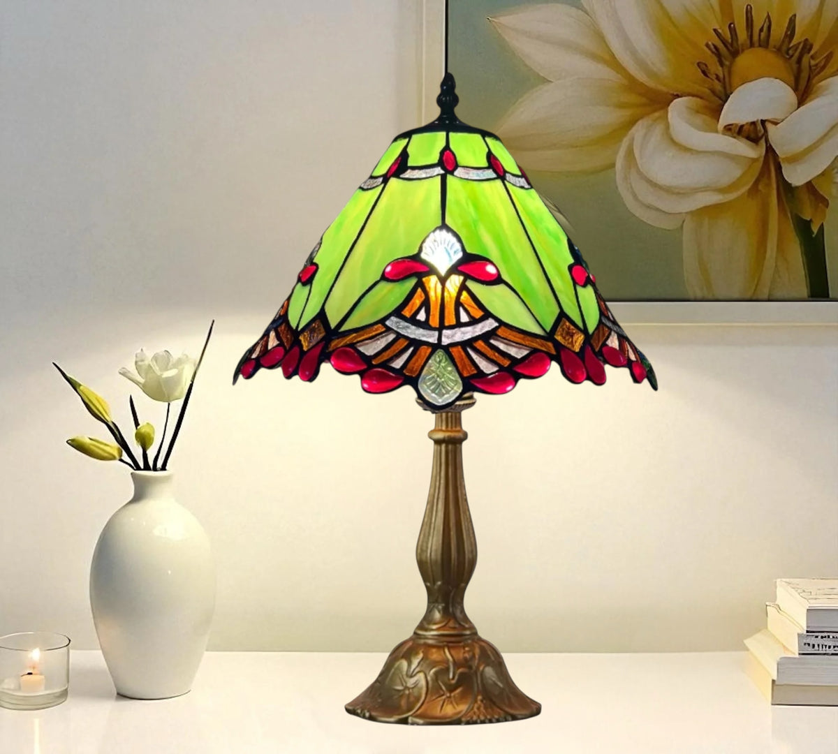 Table lamp with green stained-glass shade, red accents, and bronze base