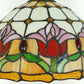 Close-up of stained-glass tulip lamp shade with multicolor floral panels