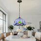 Tiffany-style stained glass pendant lamp shade hanging from dark metal chain