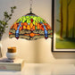 Tiffany-style stained glass pendant lamp with colorful dome shade over a plain table