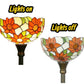 Tiffany-style stained glass floor lamp shade with dark metal torchiere base, lit