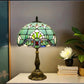 Green stained-glass shade table lamp with bronze pedestal base