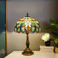 Multicolor stained glass table lamp with decorative bronze base and floral shade pattern