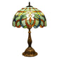 Multicolor stained glass table lamp with bronze base and scalloped shade, close-up