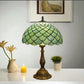 Tiffany-style table lamp with green stained-glass scalloped shade and bronze metal base
