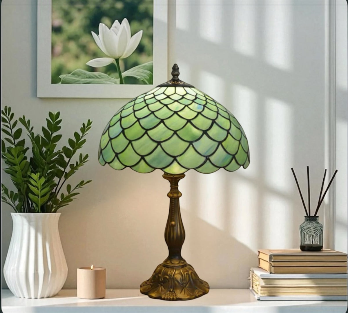 Tiffany-style table lamp three-quarter view with green stained-glass shade and bronze base