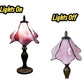 Table lamp shown lit vs unlit: pink stained-glass shade on dark base