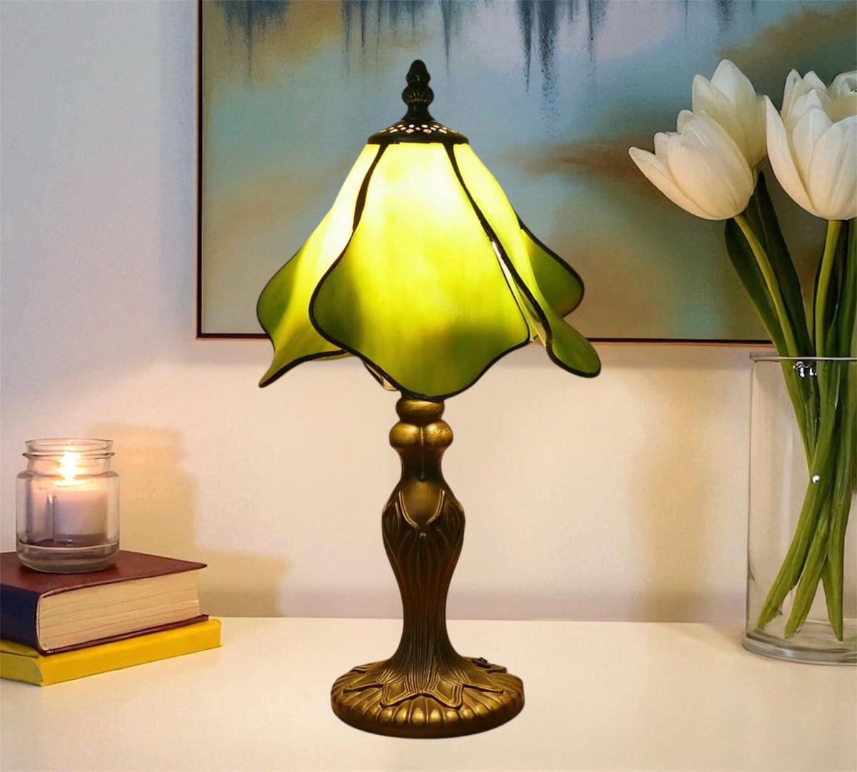 Tiffany table lamp with stained glass shade, glowing yellow-green tones, metal base