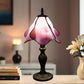 Tiffany table lamp with pink stained-glass shade and dark textured base