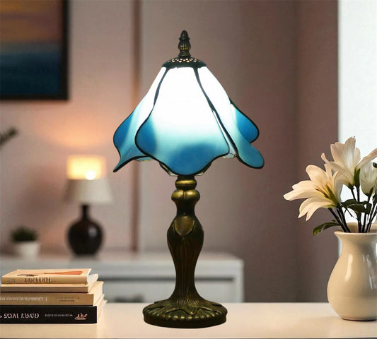 Blue stained glass table lamp with dark bronze base and dome shade