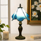 Blue stained glass Tiffany-style table lamp with bronze base and finial