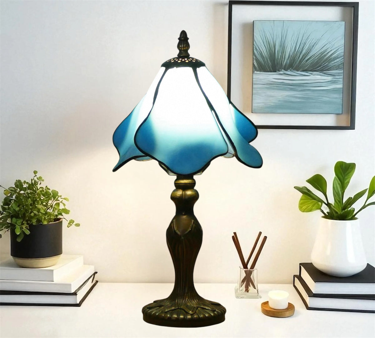 Blue and white stained glass table lamp with tall bronze pedestal base