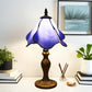 Stained glass table lamp with purple-blue shade and ornate gold base