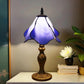 Table lamp with frosted purple-blue stained glass shade and gold metal base