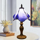 Stained glass table lamp with purple-blue shade and detailed gold base