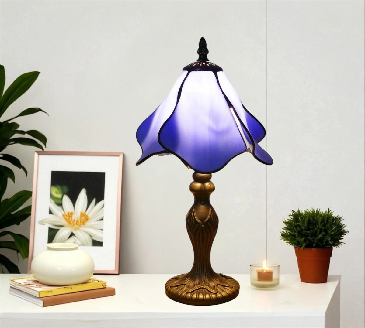 Table lamp with purple-blue stained glass shade and decorative gold metal base