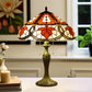 Tiffany table lamp with dome stained glass shade in orange and cream, bronze base