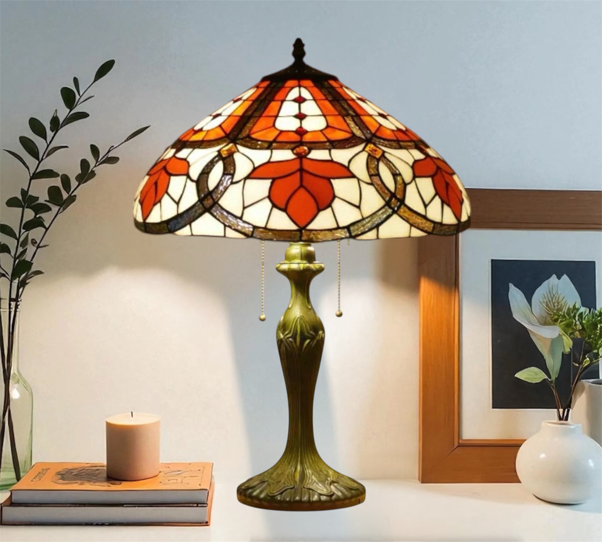 Tiffany table lamp with stained glass shade and bronze base, lit on tabletop