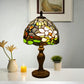 Tiffany-style stained glass table lamp with dome shade and turned bronze stand
