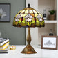 Tiffany-style stained glass table lamp with multicolor floral shade and ornate bronze pedestal base