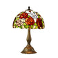 Tiffany-style stained glass table lamp with multicolor floral shade and bronze base