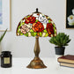 Tiffany-style stained glass table lamp with colorful floral shade and bronze metal base
