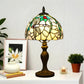 Tiffany table lamp with stained-glass dome shade and ornate dark bronze pedestal base