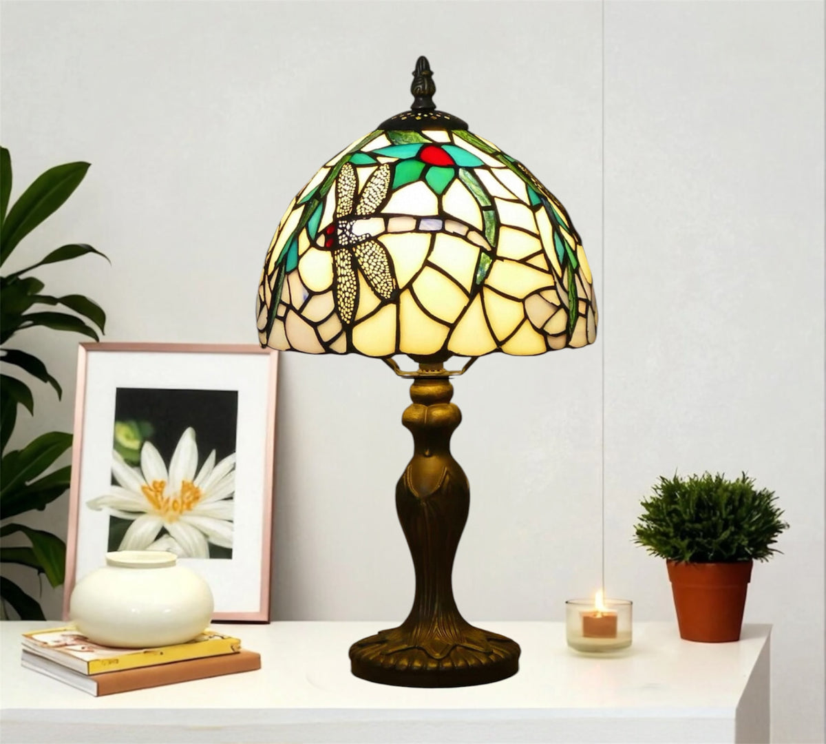 Tiffany table lamp with stained-glass dome shade and ornate dark bronze pedestal base