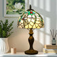 Tiffany table lamp with stained-glass dome shade and dark metal pedestal base
