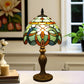 Stained-glass table lamp with multicolor dome shade and bronze pedestal base