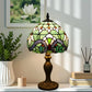 Stained glass table lamp with green floral shade and dark bronze metal base