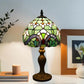 Stained glass table lamp with arched multicolor shade and dark metal pedestal base