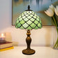 Green stained glass Tiffany table lamp with flared scalloped shade and bronze-toned base