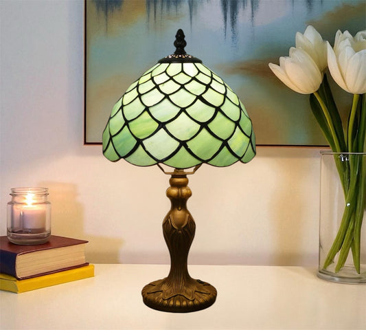 Green stained glass Tiffany table lamp with flared scalloped shade and bronze-toned base