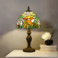 Stained glass Tiffany table lamp with multicolor floral shade and bronze metal base